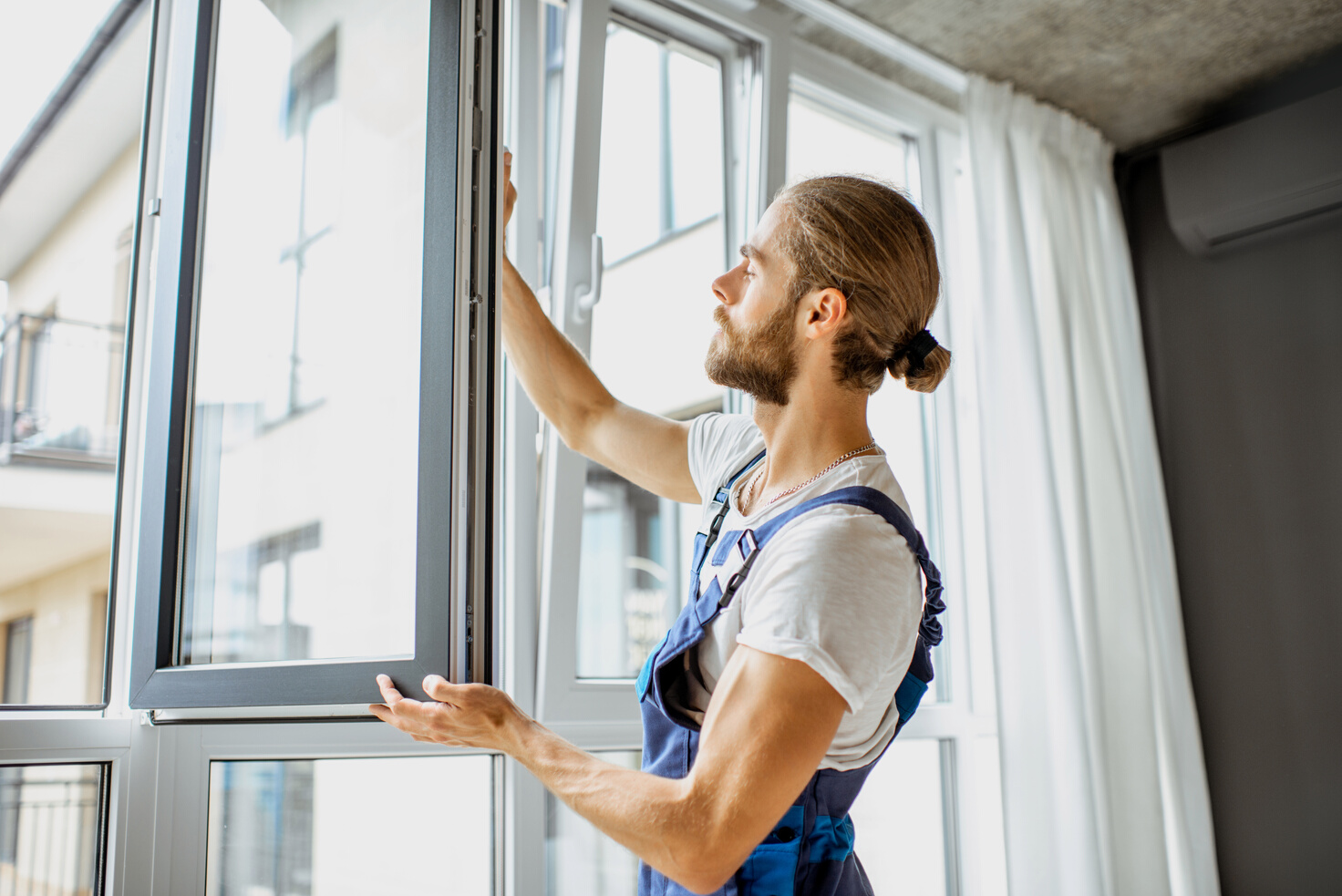 Workman Adjusting Window Frames at Home